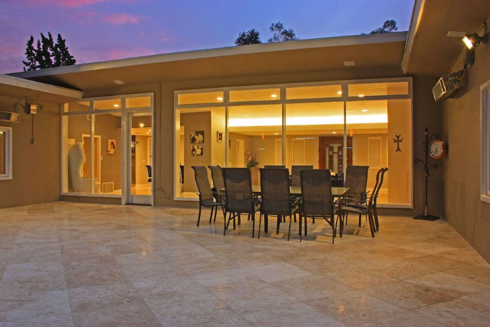 Burbank overlooking a larger pool with patio and patio furniture.