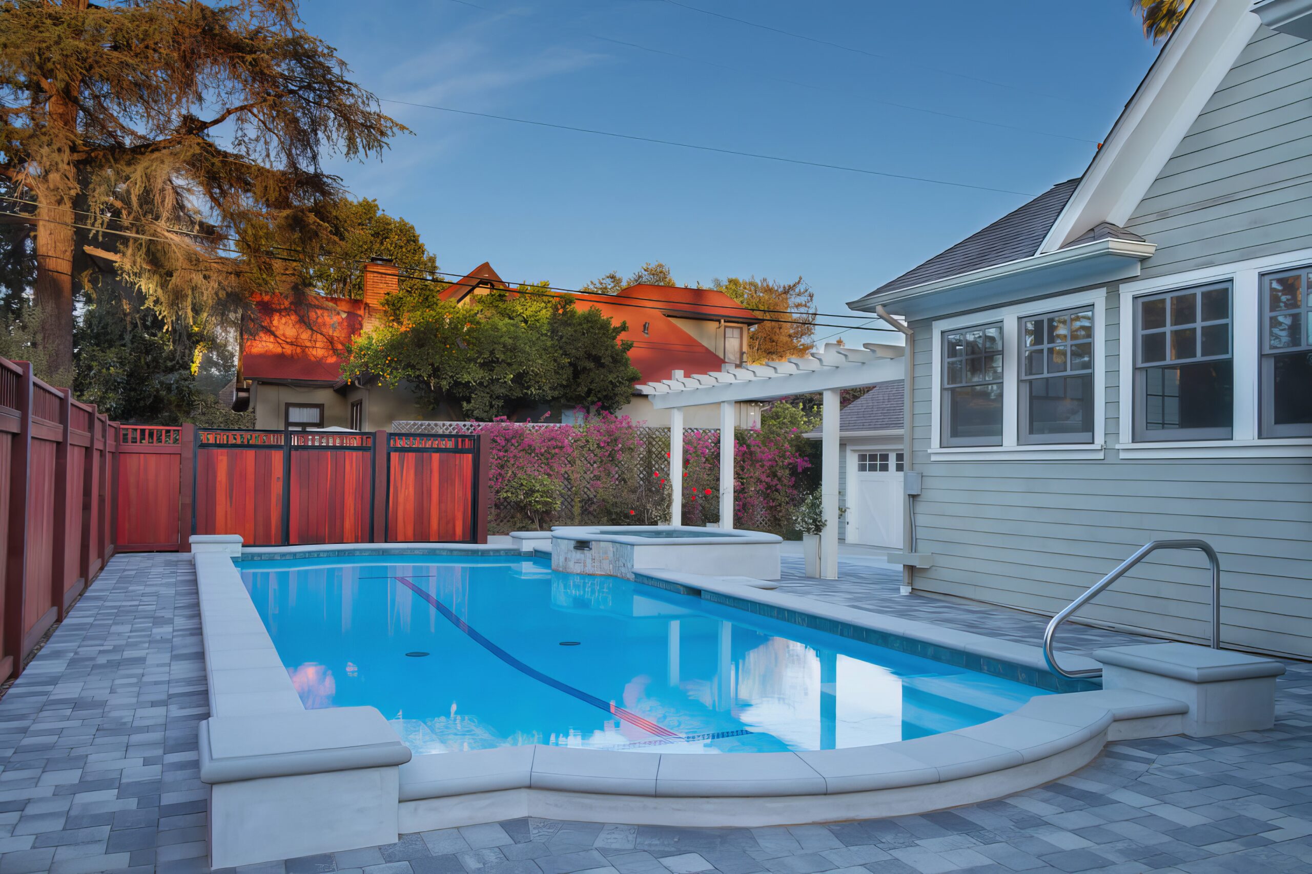 a swimming pool with a deck and a fence