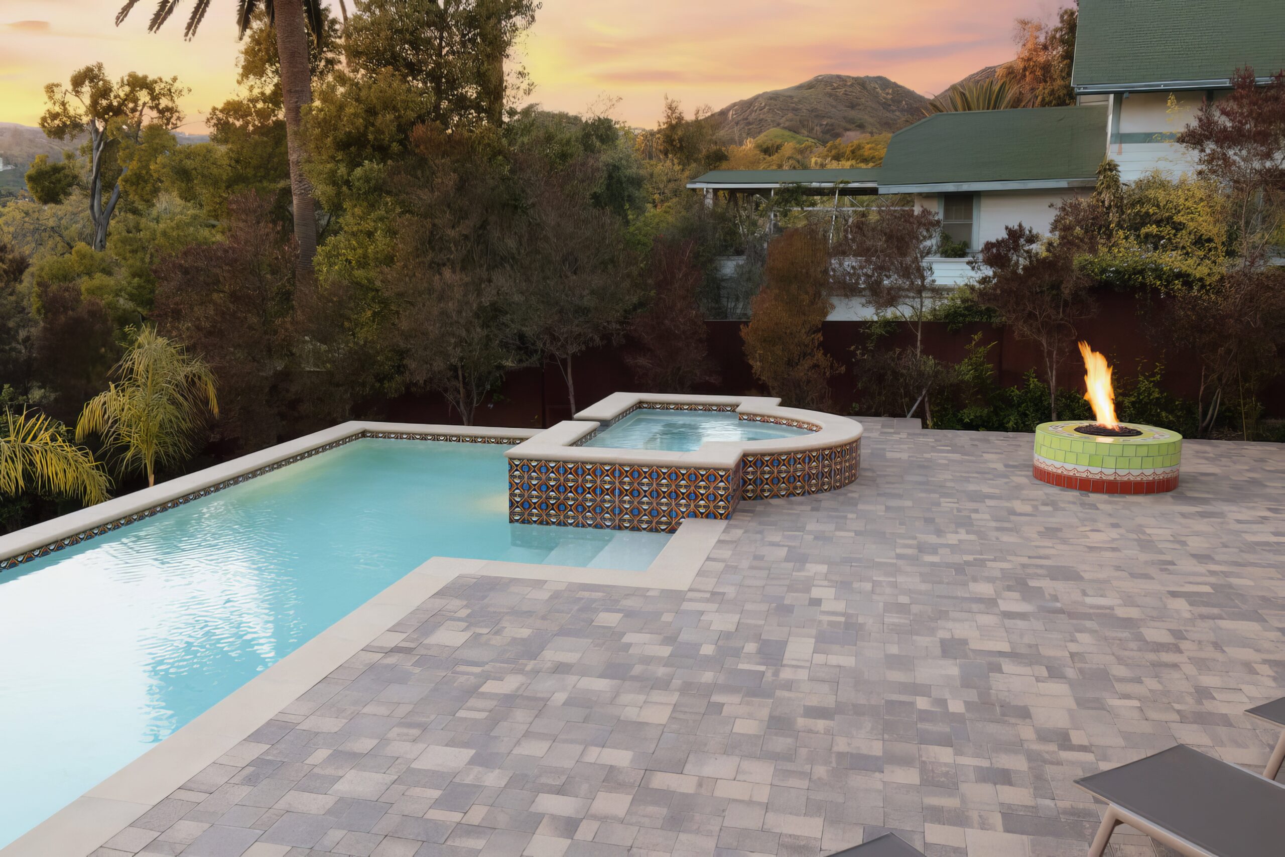 a pool with a jacuzzi in the back